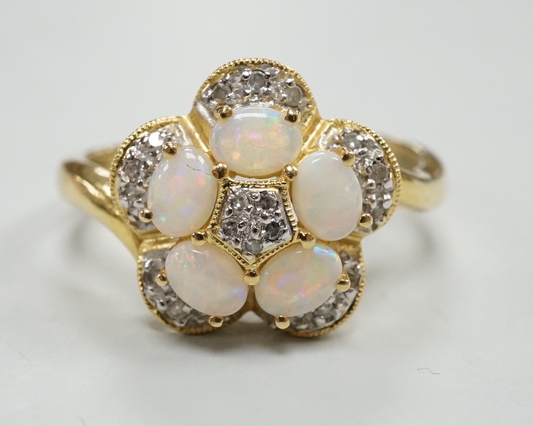 A modern 18k yellow metal, white opal and diamond chip set flower head cluster ring, size P, gross weight 4 grams.